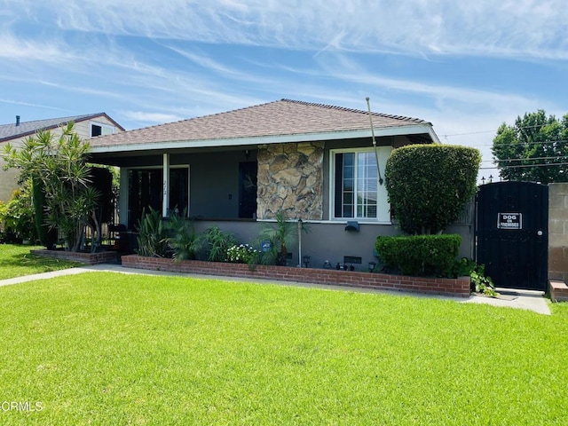 272 E 69th St, Long Beach, CA 90805 - bungalow-style house with a front yard and roof with shingles