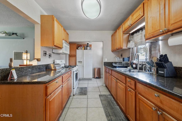 272 E 69th St, Long Beach, CA 90805 - kitchen with white appliances, light tile patterned floors, and brown cabinetry