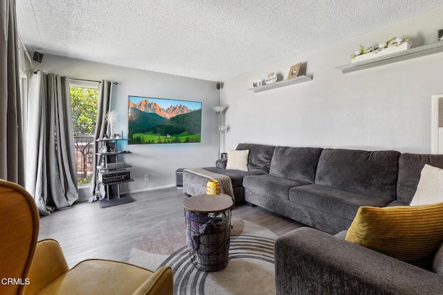 272 E 69th St, Long Beach, CA 90805 - living room with wood finished floors and a textured ceiling