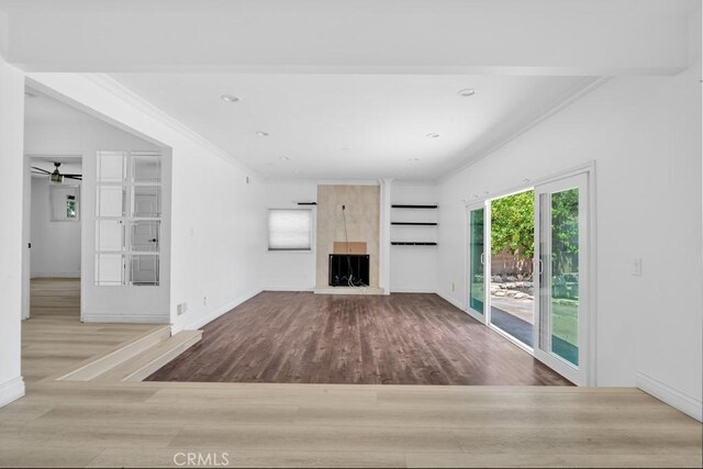 7812 Fairchild Ave, Winnetka, CA 91306 - unfurnished living room featuring wood finished floors, crown molding, a large fireplace, and ceiling fan