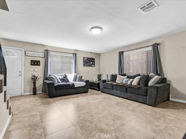 10316 S San Pedro St, Los Angeles, CA 90003 - living room with light tile patterned floors and a textured ceiling