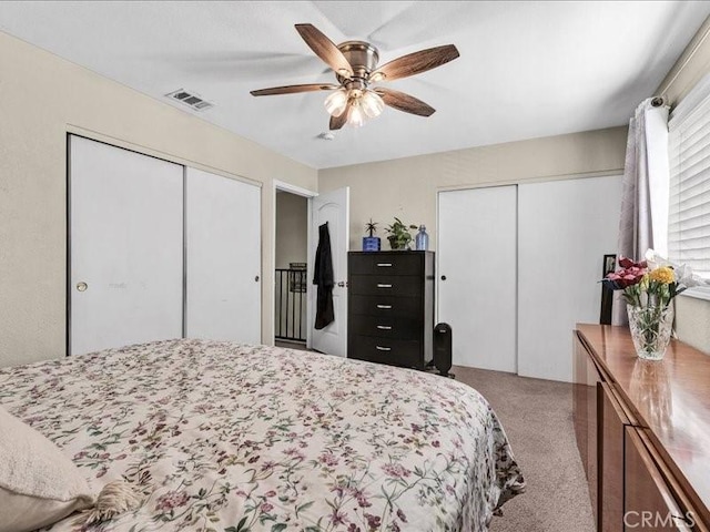 10316 S San Pedro St, Los Angeles, CA 90003 - bedroom featuring two closets, light colored carpet, and ceiling fan