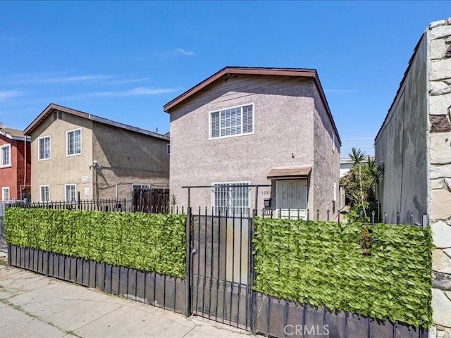 10316 S San Pedro St, Los Angeles, CA 90003 - view of front of house featuring stucco siding and a gate