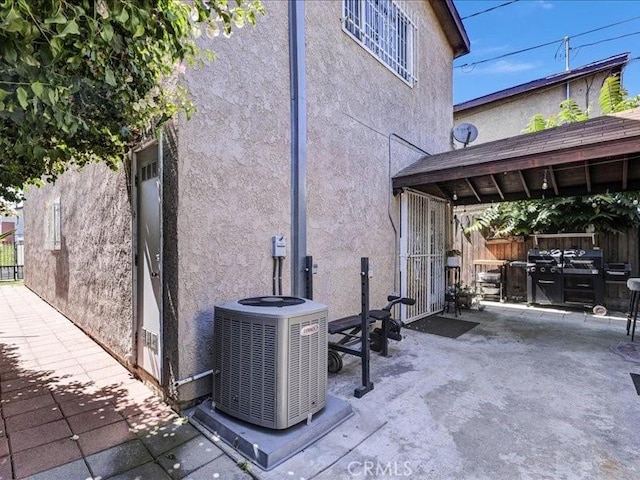 10316 S San Pedro St, Los Angeles, CA 90003 - view of side of property with stucco siding and a patio area