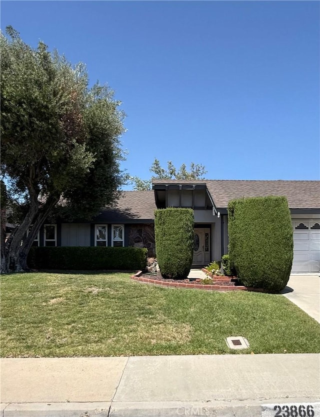 23866 Lindley St, Mission Viejo, CA 92691 - view of front facade featuring a front lawn, a garage, concrete driveway, and a shingled roof