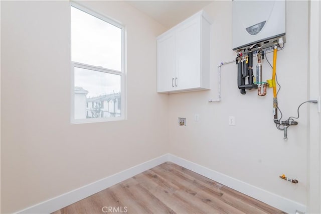 11237 Gladhill Rd Unit 12, Whittier, CA 90604 - washroom with cabinet space, light wood-style flooring, and hookup for a washing machine