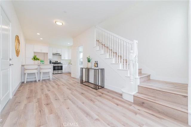 11237 Gladhill Rd Unit 12, Whittier, CA 90604 - entryway with light wood-style floors, stairway, and recessed lighting