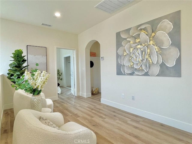 11237 Gladhill Rd Unit 12, Whittier, CA 90604 - sitting room with arched walkways, wood finished floors, and recessed lighting