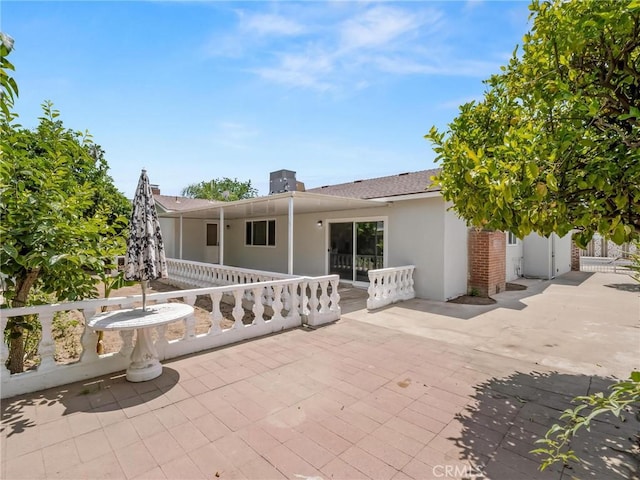 1263 Bundy Ave, Clovis, CA 93611 - back of property with stucco siding, a patio area, and roof with shingles
