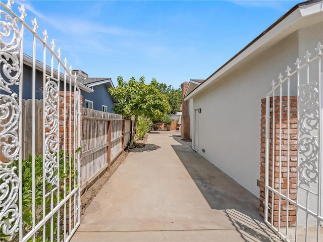 1263 Bundy Ave, Clovis, CA 93611 - view of side of property featuring stucco siding and a patio