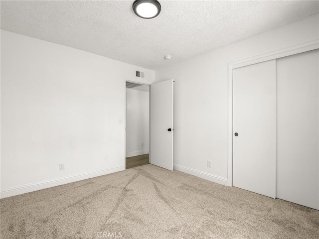 1263 Bundy Ave, Clovis, CA 93611 - unfurnished bedroom featuring carpet floors, a textured ceiling, and a closet