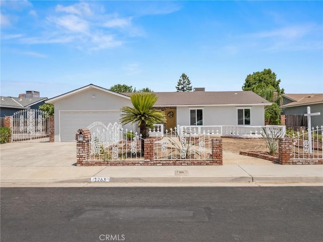 1263 Bundy Ave, Clovis, CA 93611 - ranch-style home with driveway, a fenced front yard, a garage, and stucco siding