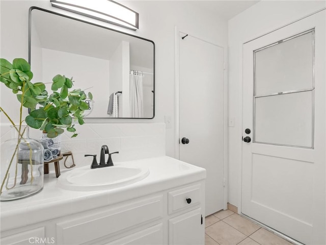 1263 Bundy Ave, Clovis, CA 93611 - full bath featuring vanity, tile patterned flooring, decorative backsplash, and a shower with curtain