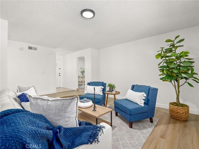 1263 Bundy Ave, Clovis, CA 93611 - living area with wood finished floors and a textured ceiling