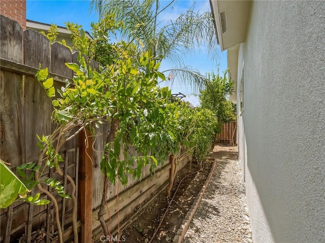 1263 Bundy Ave, Clovis, CA 93611 - view of side of home with a fenced backyard and stucco siding