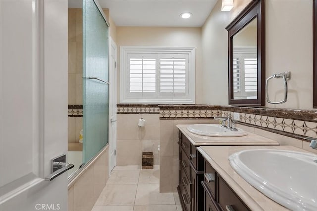 6636 Wooster Ave, Los Angeles, CA 90056 - full bath featuring healthy amount of natural light, double vanity, tile walls, bathing tub / shower combination, and tile patterned flooring