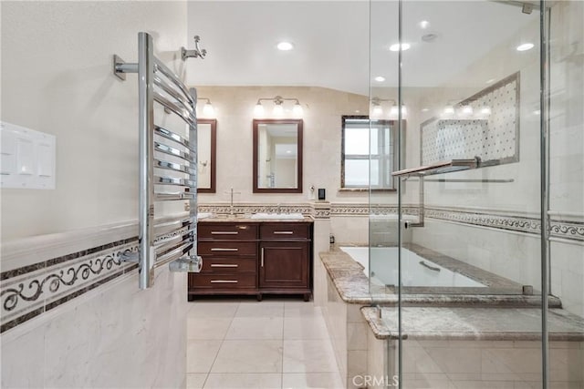 6636 Wooster Ave, Los Angeles, CA 90056 - bathroom featuring vanity, a bath, a shower stall, a towel warming rack, and tile walls