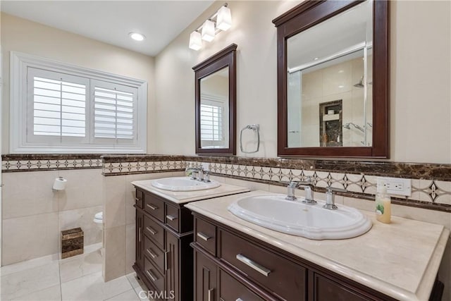 6636 Wooster Ave, Los Angeles, CA 90056 - full bath featuring tile walls, two vanities, a tile shower, tile patterned flooring, and wainscoting
