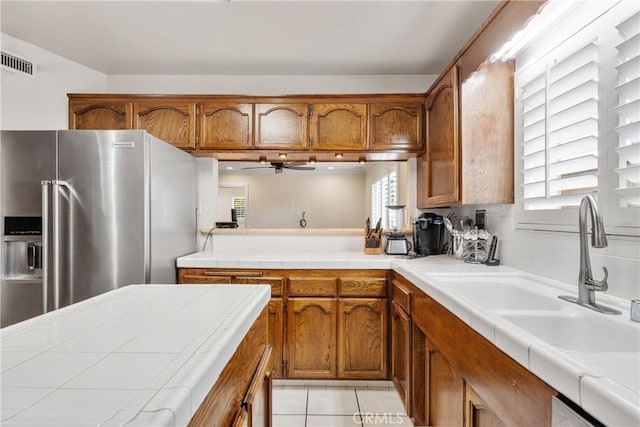 6636 Wooster Ave, Los Angeles, CA 90056 - kitchen featuring high end fridge, brown cabinets, and plenty of natural light