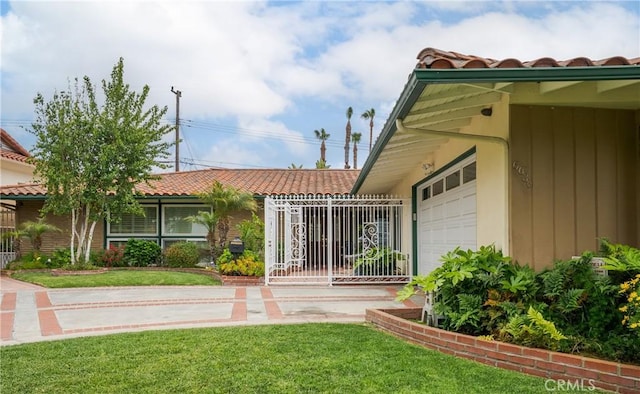 6636 Wooster Ave, Los Angeles, CA 90056 - doorway to property featuring a tiled roof, a garage, and a yard