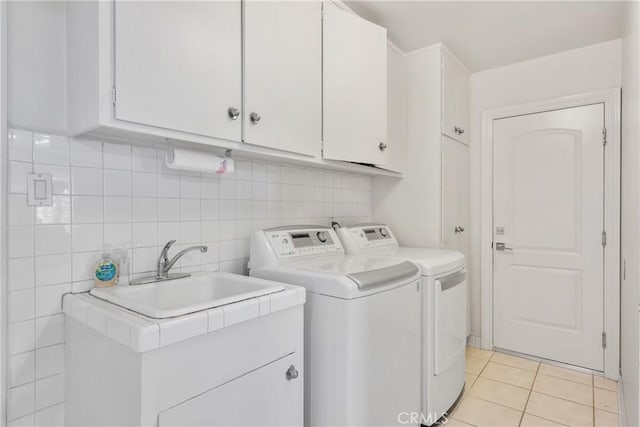 6636 Wooster Ave, Los Angeles, CA 90056 - washroom featuring cabinet space, washing machine and dryer, and light tile patterned floors