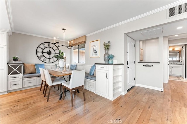201 Bay Shore Ave Unit 305, Long Beach, CA 90803 - dining area with breakfast area, crown molding, light wood-style flooring, and a chandelier