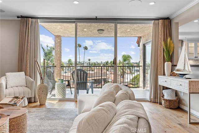 201 Bay Shore Ave Unit 305, Long Beach, CA 90803 - living area featuring healthy amount of natural light, ornamental molding, wood finished floors, floor to ceiling windows, and recessed lighting