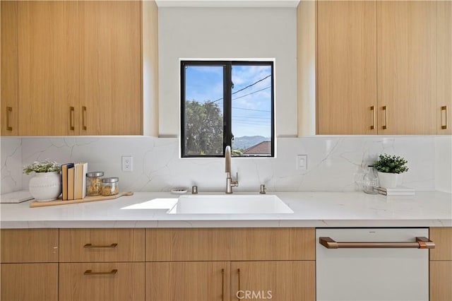 2414 Las Positas Rd, Glendale, CA 91208 - kitchen with white dishwasher, light brown cabinetry, light stone counters, and decorative backsplash