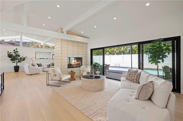2414 Las Positas Rd, Glendale, CA 91208 - living area with light wood-style flooring, beam ceiling, high vaulted ceiling, recessed lighting, and a multi sided fireplace
