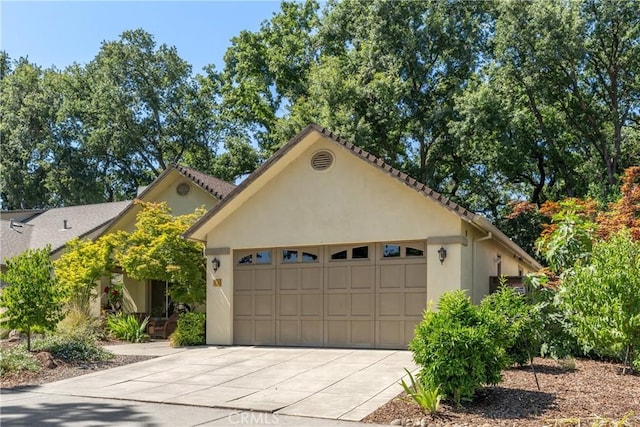 17 Arminta Ct, Chico, CA 95928 - mediterranean / spanish-style house with concrete driveway, stucco siding, and a garage