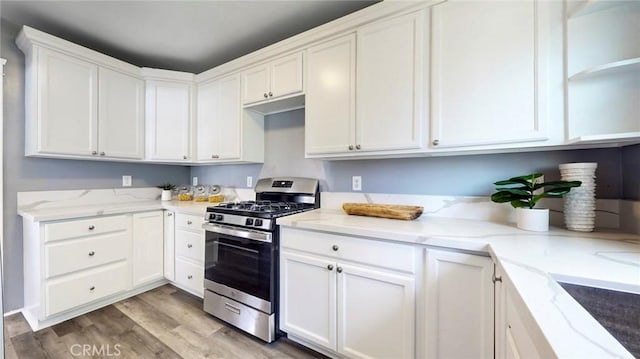 243 N Verdugo Rd, Glendale, CA 91206 - kitchen with stainless steel range with gas cooktop, white cabinetry, light wood-type flooring, light stone countertops, and open shelves