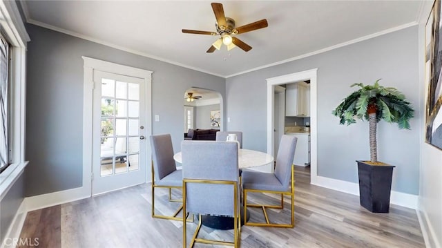 243 N Verdugo Rd, Glendale, CA 91206 - dining area featuring a ceiling fan, wood finished floors, crown molding, and arched walkways