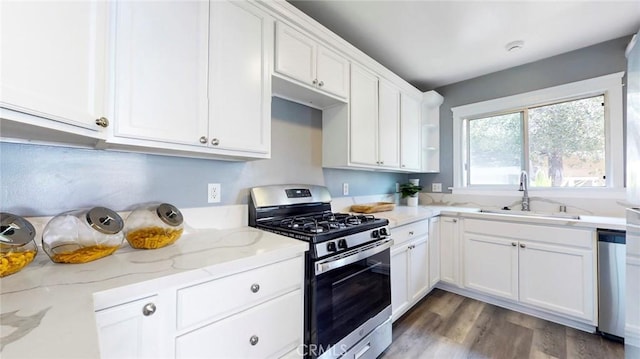 243 N Verdugo Rd, Glendale, CA 91206 - kitchen with appliances with stainless steel finishes, white cabinetry, light stone countertops, and wood finished floors