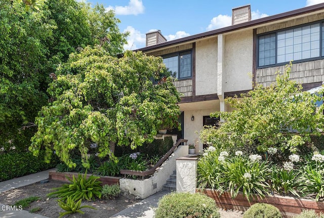 301 Wallis St Unit 8, Pasadena, CA 91106 - view of front facade with stucco siding and a chimney