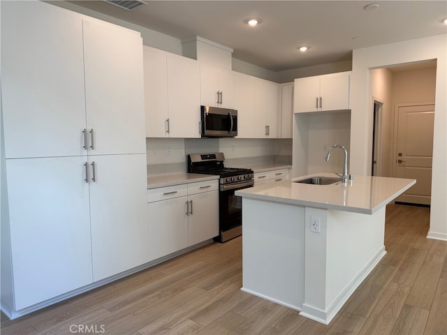 15929 Blue Copper Way, Fontana, CA 92336 - kitchen with appliances with stainless steel finishes, light wood-type flooring, light countertops, white cabinetry, and recessed lighting