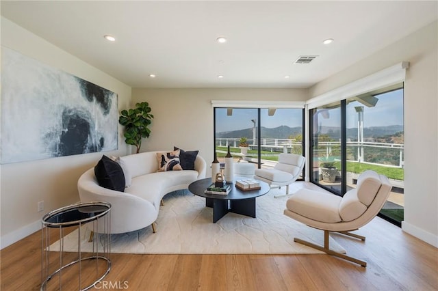 15541 Aqua Verde Dr, Los Angeles, CA 90077 - living room featuring wood finished floors, healthy amount of natural light, recessed lighting, and a mountain view