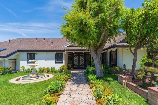 15541 Aqua Verde Dr, Los Angeles, CA 90077 - view of front of home with french doors, stucco siding, a front yard, and roof with shingles