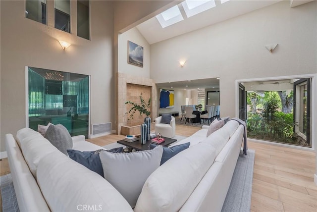 15541 Aqua Verde Dr, Los Angeles, CA 90077 - living area with high vaulted ceiling, a skylight, and wood finished floors