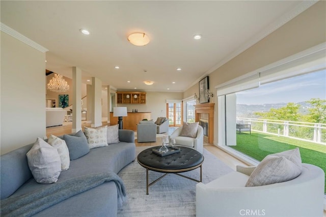 15541 Aqua Verde Dr, Los Angeles, CA 90077 - living area with ornamental molding, a glass covered fireplace, a chandelier, recessed lighting, and light wood-style flooring