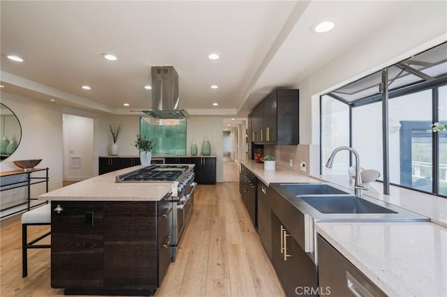 15541 Aqua Verde Dr, Los Angeles, CA 90077 - kitchen featuring island range hood, double oven range, a tray ceiling, light wood-type flooring, and recessed lighting