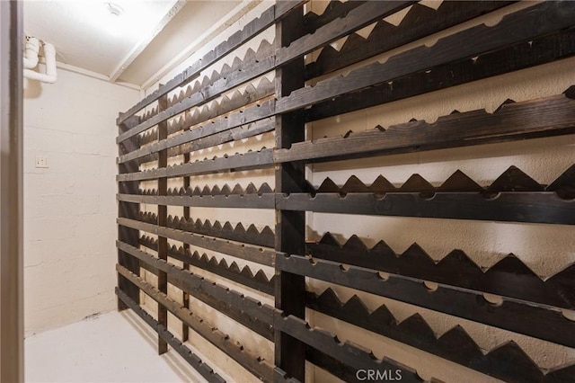 15541 Aqua Verde Dr, Los Angeles, CA 90077 - wine area featuring finished concrete floors and concrete block wall