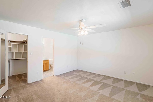 4810 Bluestone Dr, Bakersfield, CA 93311 - unfurnished bedroom with light carpet, a spacious closet, a closet, a ceiling fan, and ensuite bathroom