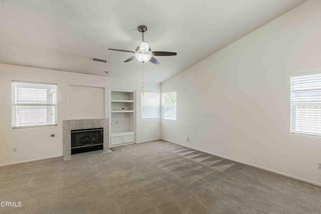 4810 Bluestone Dr, Bakersfield, CA 93311 - unfurnished living room featuring a ceiling fan, light colored carpet, a tiled fireplace, lofted ceiling, and built in shelves