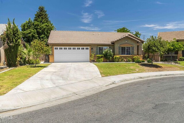 4810 Bluestone Dr, Bakersfield, CA 93311 - view of front of property featuring a tile roof, stucco siding, driveway, and an attached garage