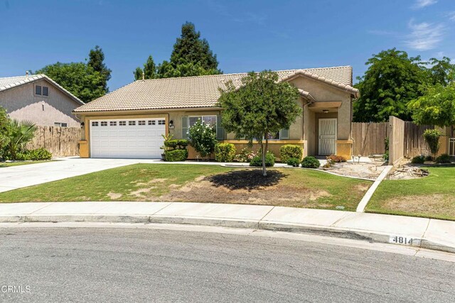 4810 Bluestone Dr, Bakersfield, CA 93311 - view of front of property featuring a tiled roof, an attached garage, concrete driveway, and stucco siding