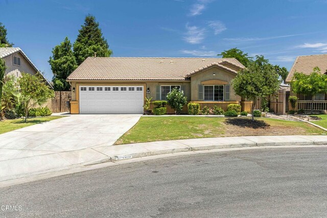 4810 Bluestone Dr, Bakersfield, CA 93311 - view of front of property featuring a tiled roof, stucco siding, a garage, and driveway