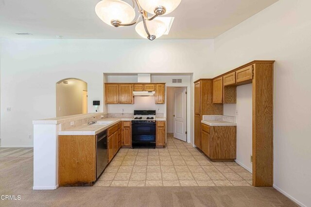 4810 Bluestone Dr, Bakersfield, CA 93311 - kitchen featuring gas range, stainless steel dishwasher, under cabinet range hood, a peninsula, and brown cabinets