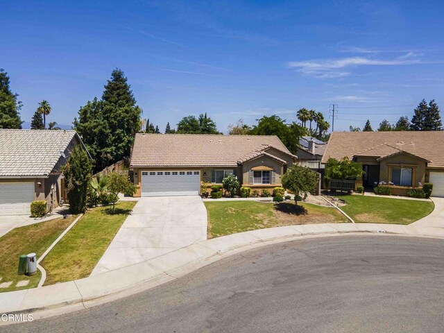 4810 Bluestone Dr, Bakersfield, CA 93311 - ranch-style house featuring a tile roof, driveway, a front lawn, and stucco siding