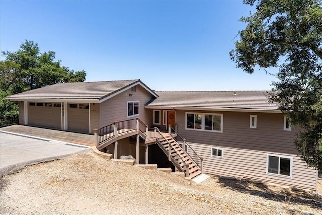 8412 Alta Vista Ave, Atascadero, CA 93422 - view of front facade with stairway, a tile roof, a detached garage, and a deck