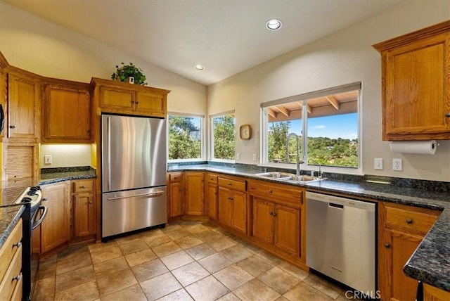 8412 Alta Vista Ave, Atascadero, CA 93422 - kitchen featuring appliances with stainless steel finishes, brown cabinets, recessed lighting, lofted ceiling, and dark stone counters